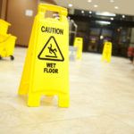 Caution, wet floor sign with mop bucket